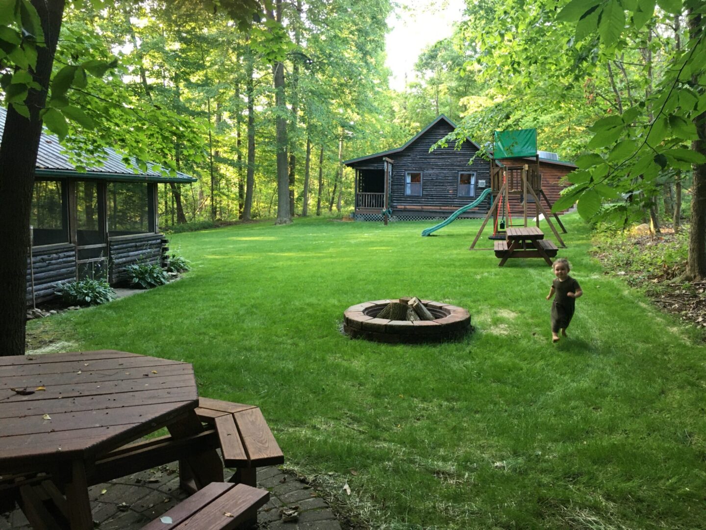 A backyard with a fire pit and picnic table.