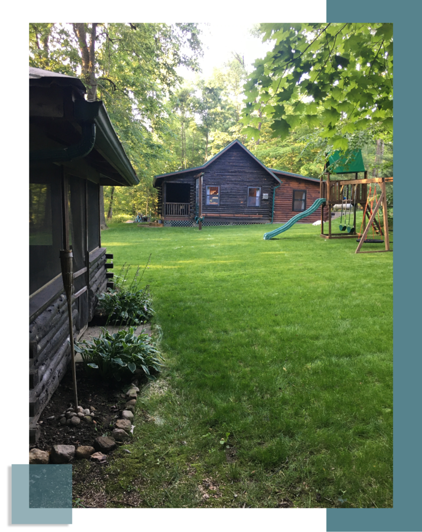 A house with a swing set in the background.