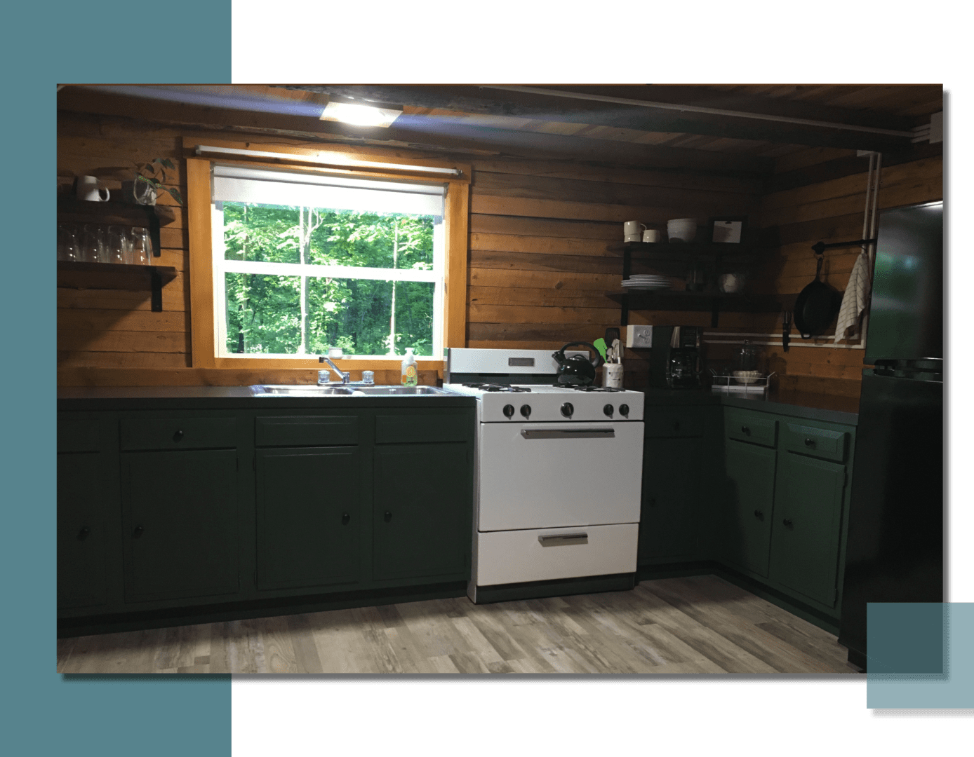 A kitchen with green cabinets and white appliances.